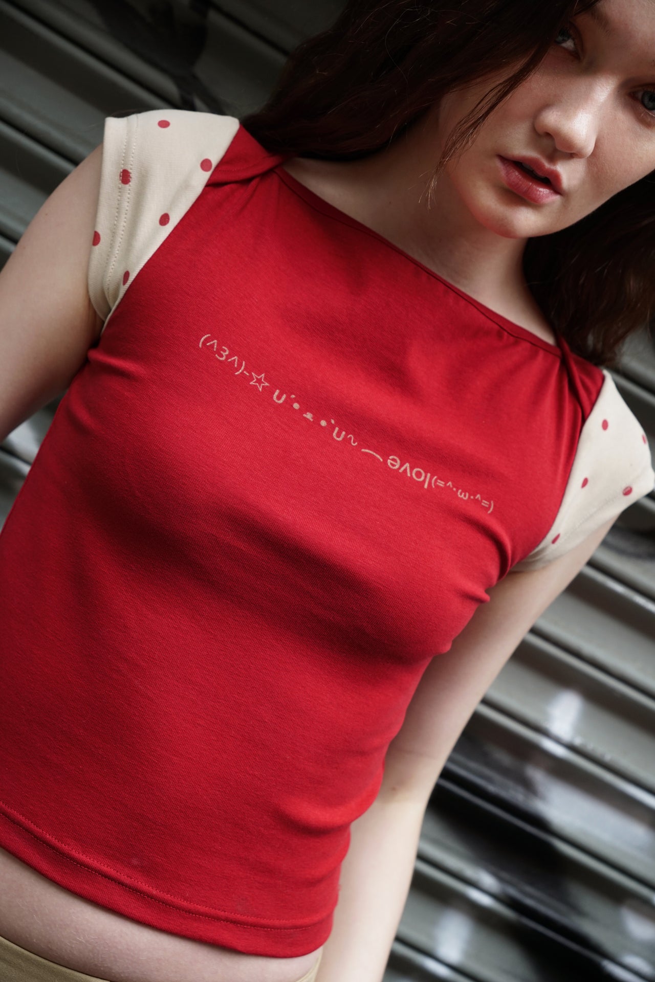 Get ready to feel cute and confident in our Pre-Order Polkadot Crop Top Red! This adorable cotton crop top features a fun emoji text print on the front and playful polkadot sleeves. You won't want to miss out on this must-have top that will make you stand out in a crowd!
