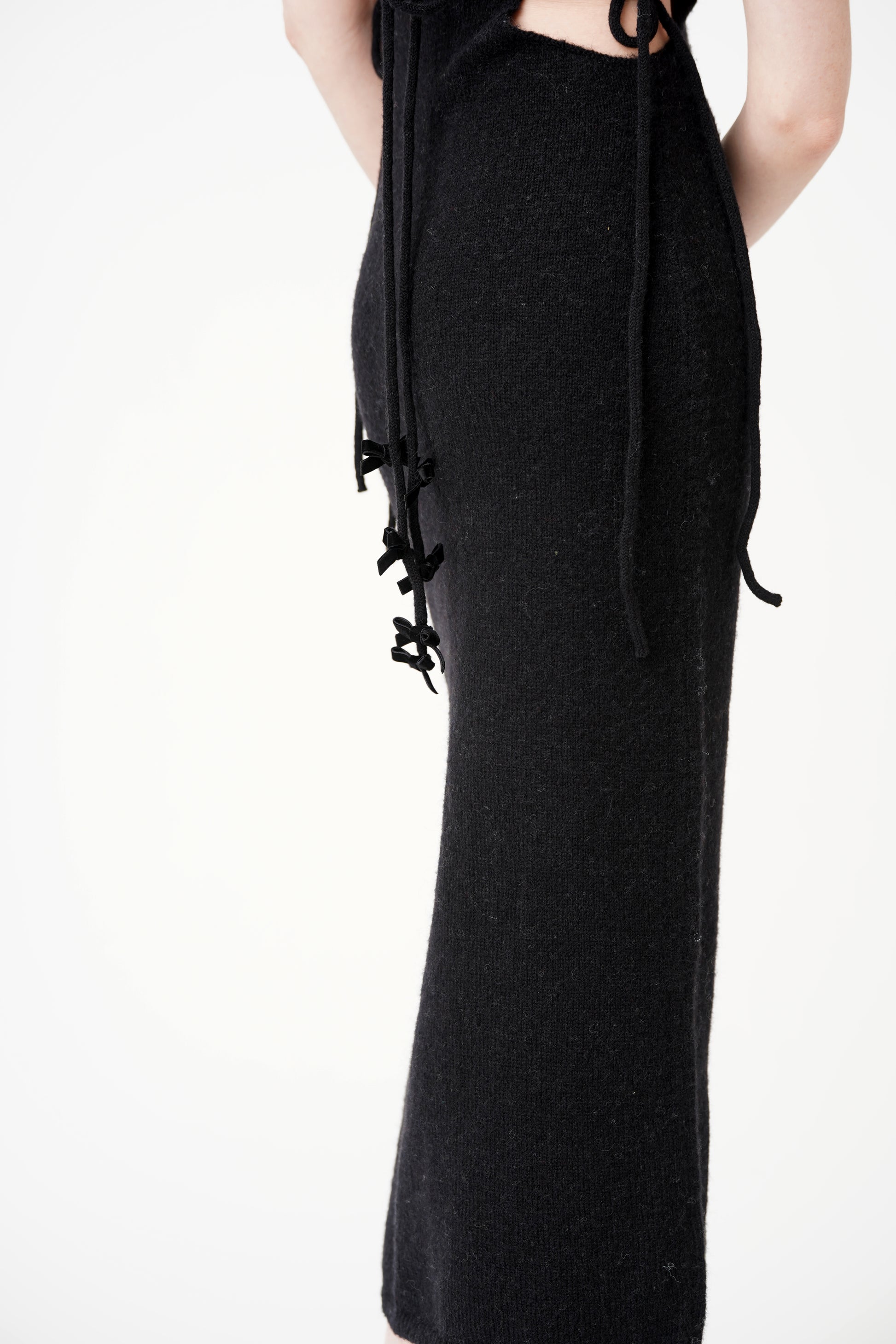 Get tied up in style with our Tie Me Knit Midi Dress! This chic dress will have you looking effortlessly fashionable in a classic black color. Made for the fun and fashionable, this dress is perfect for any occasion.