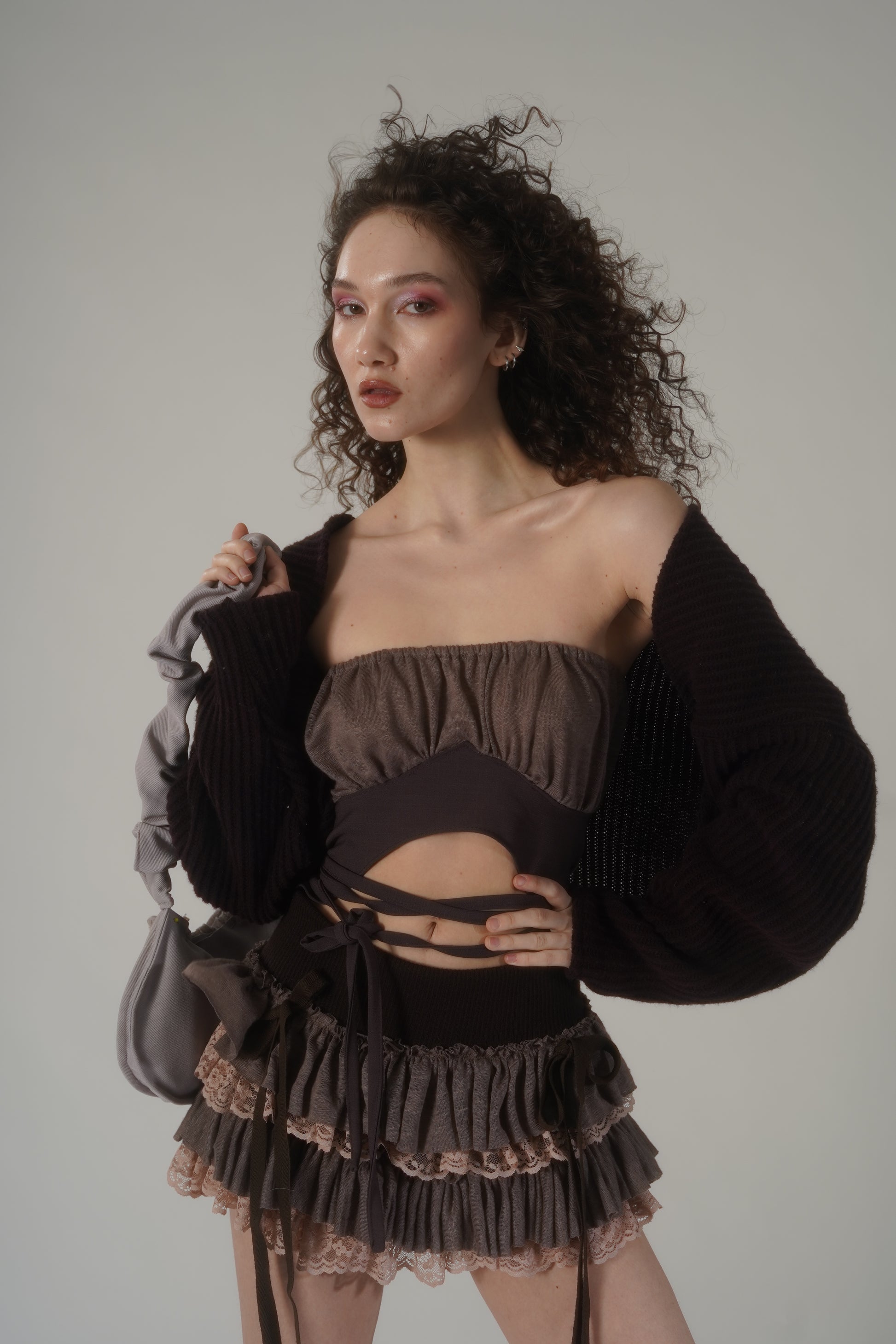 Introducing our Baby Rag Doll Tutu Skirt in Brown.This adorable skirt is made from high-quality wool knit and delicate lace, providing a rich and textured feel that sets it apart from other skirts.The soft pink and brown tones blend beautifully, creating a nostalgic and dreamy look perfect for the fall season.