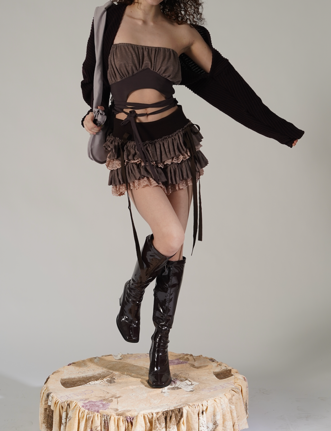 Introducing our Baby Rag Doll Tutu Skirt in Brown.This adorable skirt is made from high-quality wool knit and delicate lace, providing a rich and textured feel that sets it apart from other skirts.The soft pink and brown tones blend beautifully, creating a nostalgic and dreamy look perfect for the fall season.